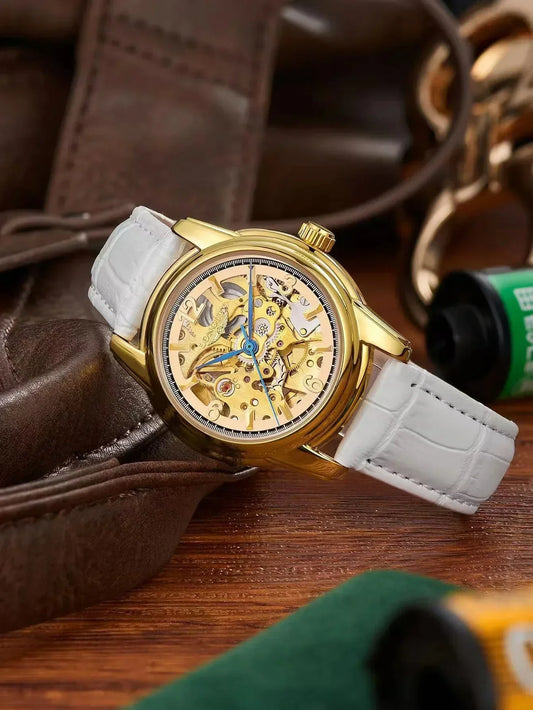 Gold skeleton watch with white leather strap on leather background, luxury fashion accessory