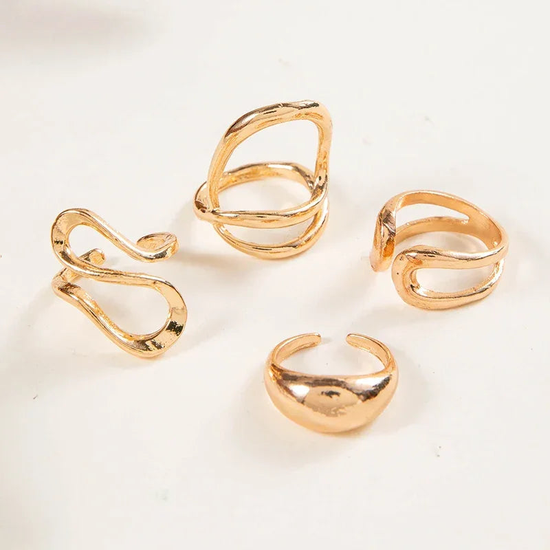 Set of four modern gold-tone adjustable rings on white background, danastors fashion jewelry