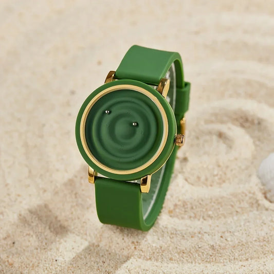 Green modern fashion watch with gold trim on sand, stylish accessory at danastors online shop
