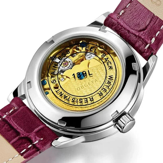 Luxury mechanical wristwatch with gold visible movement, stainless steel back, and purple leather strap