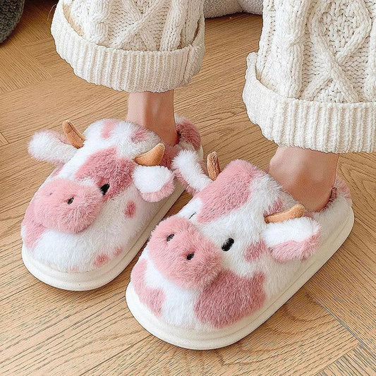 Pink cow plush slippers on feet, cozy knit pants, wooden floor, danastors fashion