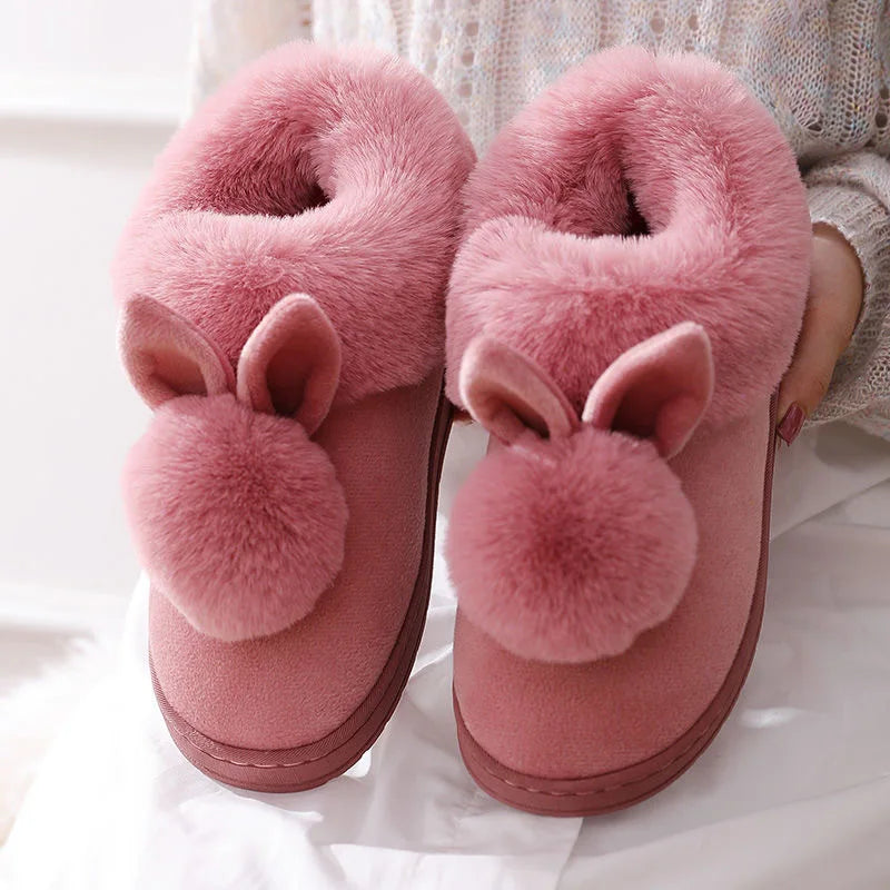 Pink fuzzy bunny ear slippers for women with plush pom-poms, cozy indoor footwear