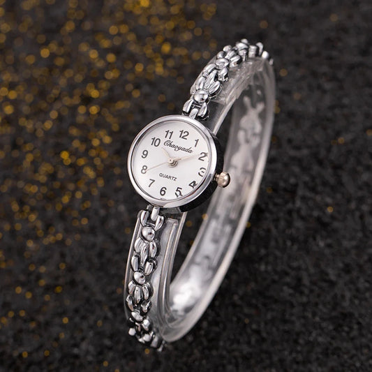 Reloj de aleación con cristal dorado y esfera pequeña