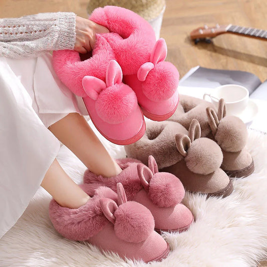 Cute fluffy bunny ear slippers in pink and brown on a cozy rug, danastors fashion.