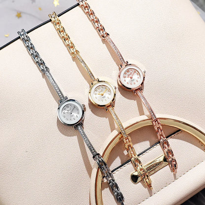 Reloj de cuarzo pequeño con esfera de números arábigos.