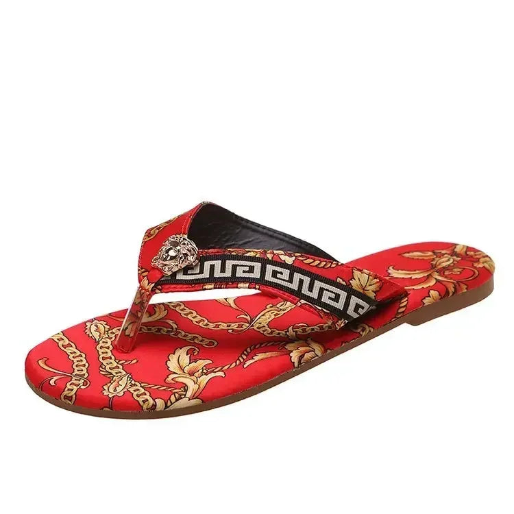 Red fashion sandal with gold chain and leaf pattern, black and white trim, decorative accent